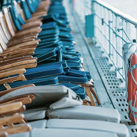 Cruise Ship Oceanliner Travel Risk and Crisis Management. Empty Deckchairs on Main Deck of the Vessel.